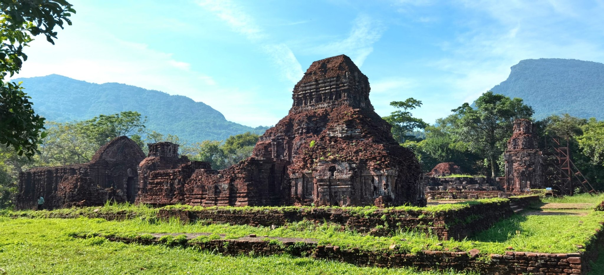 Ancient Cham brick temple towers at My Son Sanctuary under a blue sky