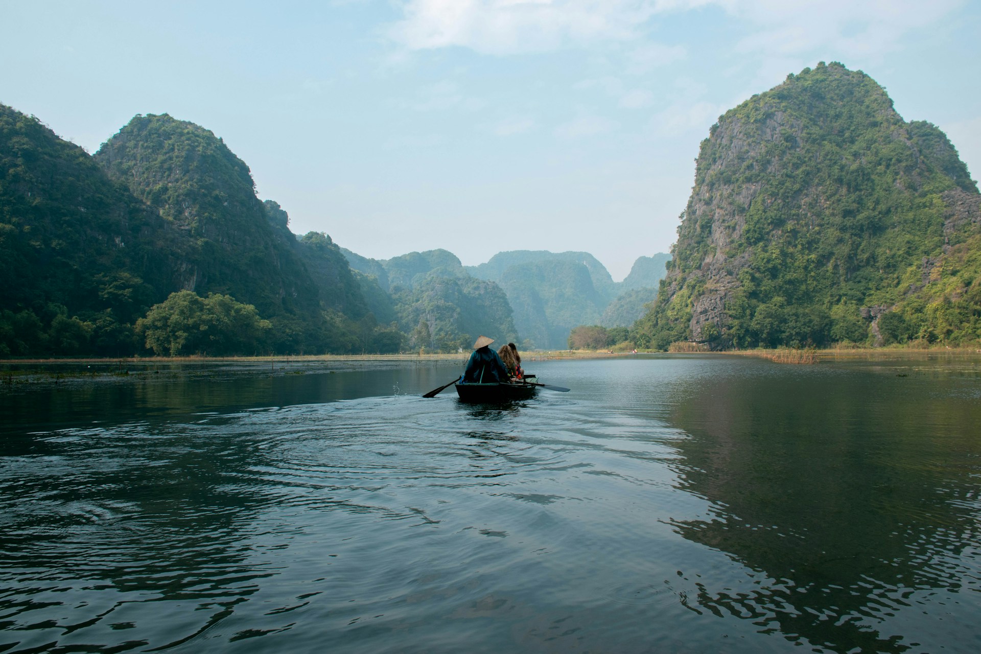 Boat on the river between limestone karsts in Ninh Binh
